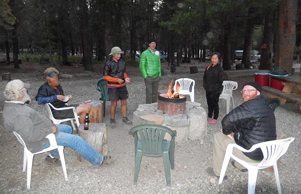 Jeanne and David with PCT thu-hikers sitting around the evening fire [2014]