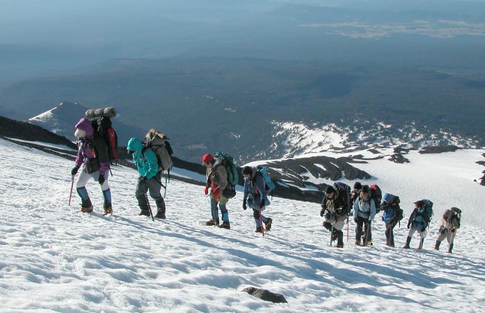 A conga line of mountaineers on their way to the summit of Mt. Adams.