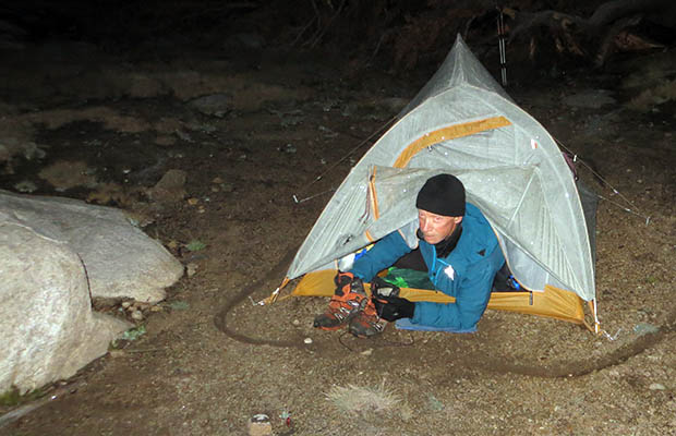 Bubbs Creek nightmare: frozen in our tents - Peter crawling out under the vestibule fly