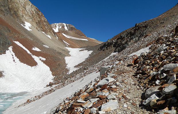 Traversing the trail below McGee Pass, with a steep snow section ahead