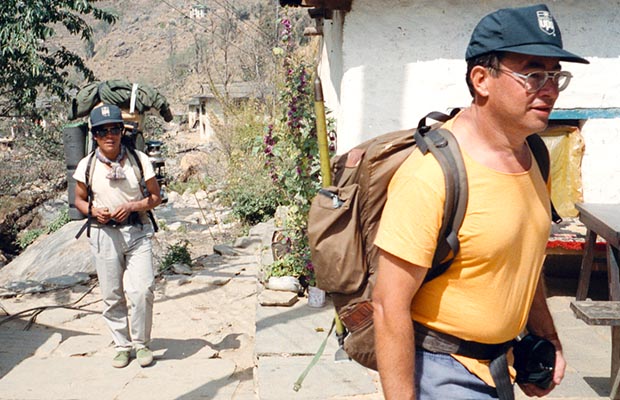 Sherpa Dorje and Martin passing through a village.